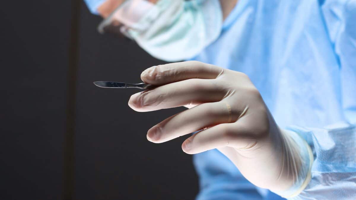 Man surgeon holds a scalpel in an operating room